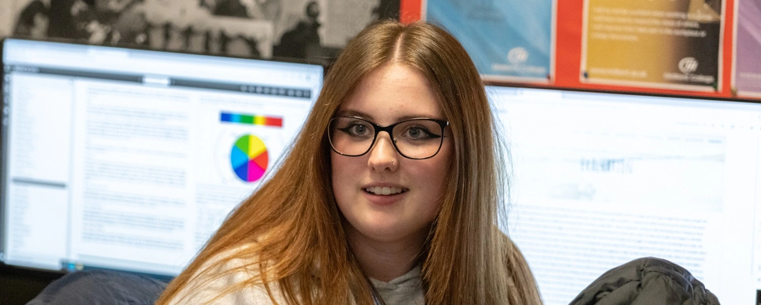 Media student in front of a computer